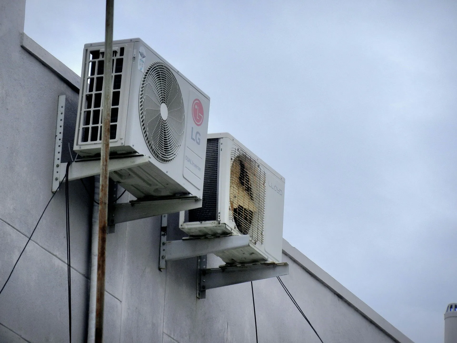 Two lg air conditioners are mounted on the side of a building. AC installation in Gresham OR